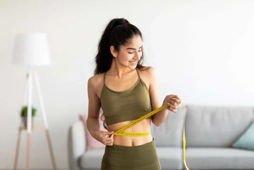 Woman Measuring Her Waist With Tape in Chesterfield, MO | Forever Weight Loss Clinic
