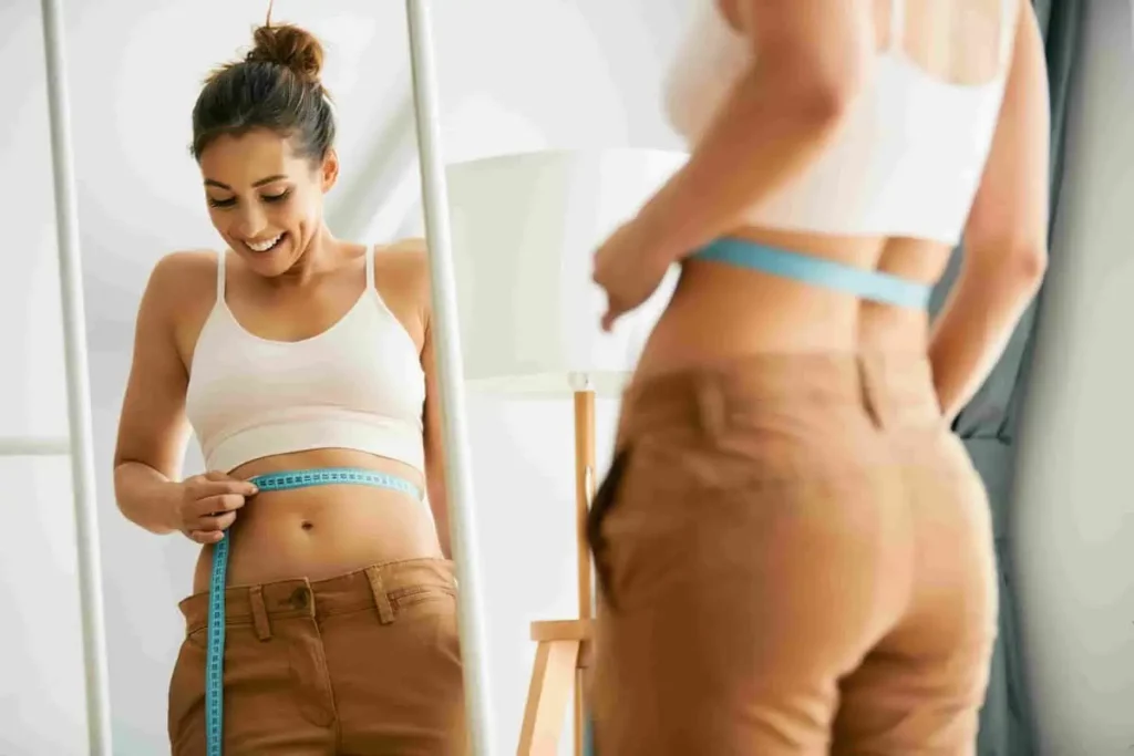 Woman Measuring Her Waist With Tape in Chesterfield, MO | Forever Weight Loss Clinic