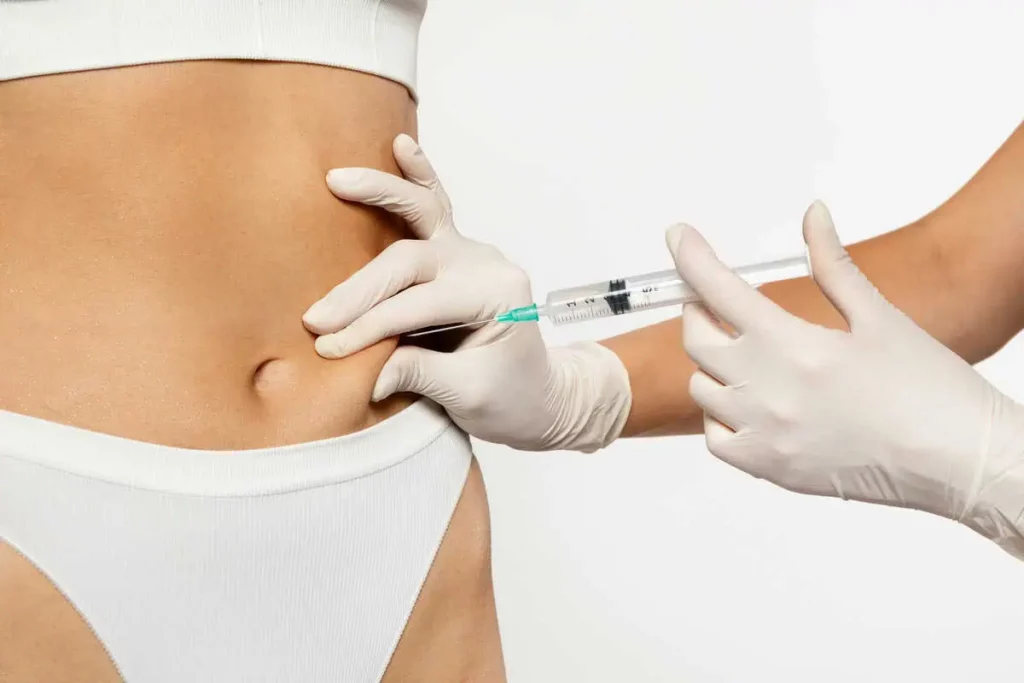 Gloved Hands Administering A Weight Loss Injection Into A Woman’s Abdomen in Chesterfield, MO | Forever Weight Loss Clinic