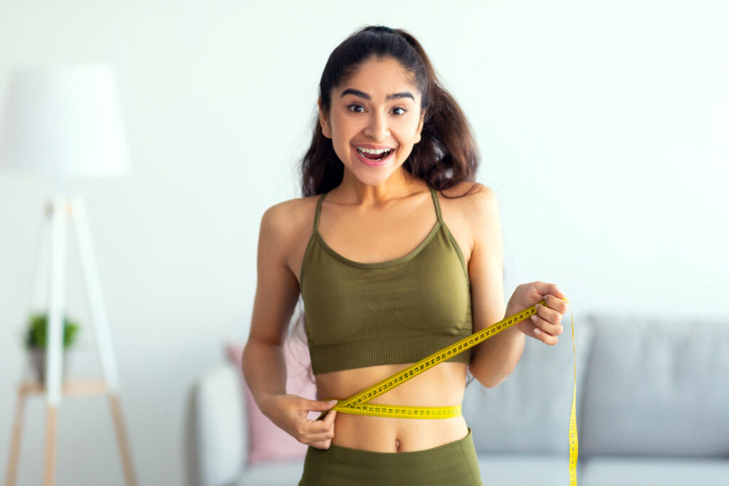 Fit Woman Measuring Her Waist in Chesterfield, MO | Forever Weight Loss Clinic