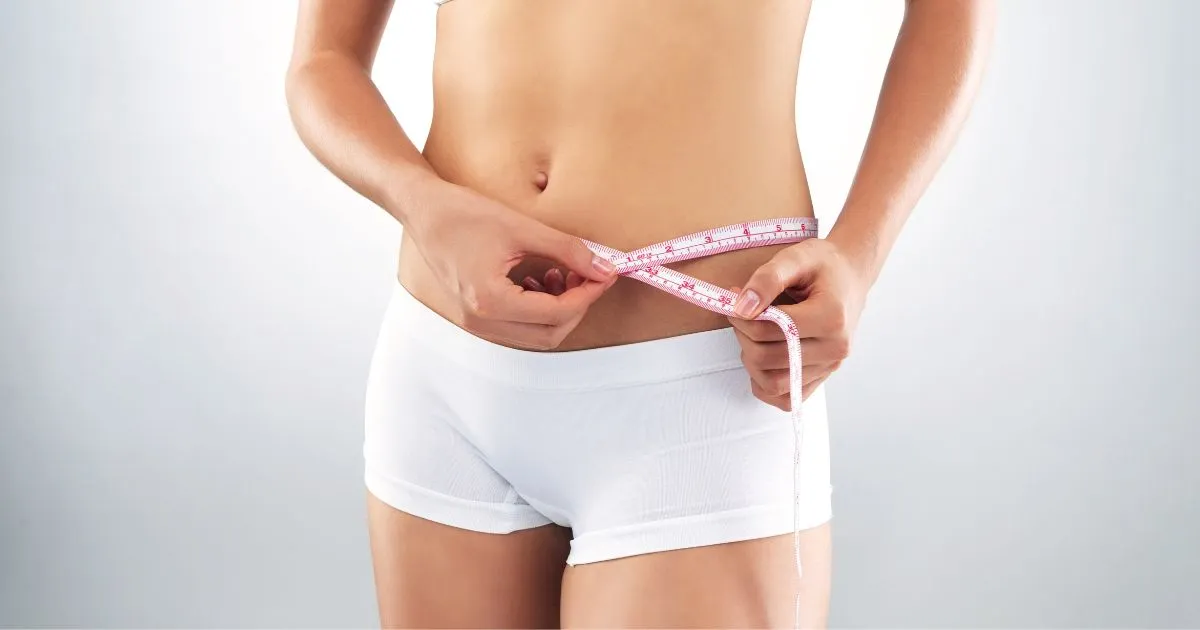 Woman measuring her waist in Chesterfield, MO, symbolizing weight loss progress